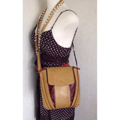 Vintage Cartier yellow mustard leather shoulder purse with gold-tone logo charm and wine leather tassel charm. Must de cartier collection