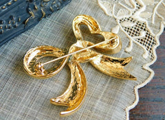 Vintage Nina Ricci golden bow brooch. Must have vintage jewelry piece back in the old era. 0406101