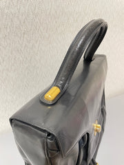 Vintage Bally black leather retro pop design bag, business purse with gold tone drawstrings and unique flap cut design. Unisex use. 160315
