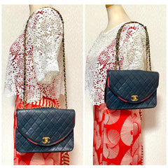 80's vintage Chanel dark navy lambskin 2.55 classic shoulder bag with gold chain and turn lock cc closure. Unique oval red edges. 051205ac4