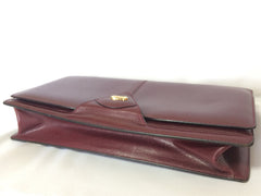Vintage Bally wine leather clutch bag, party and classic purse with gold tone logo motif.