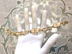 Vintage Roberta di Camerino chain bracelet with white logo charms. Beautiful jewelry.