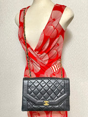 Vintage Chanel black lambskin chain 2.55 shoulder bag with gold chain. Unique hexagon shaped flap. 0407012