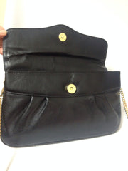 Vintage Christian Dior Vintage black leather clutch purse, mini bag, with golden Dior motif and gold tone chains.