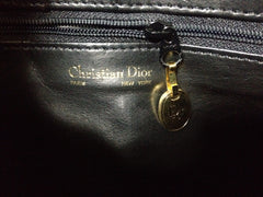 Vintage Christian Dior Vintage black leather clutch purse, mini bag, with golden Dior motif and gold tone chains.