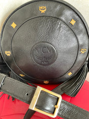 Vintage MCM black suzy wong, grained leather round shoulder bag with golden logo studs and fringes. Designed by Michael Cromer.0407051