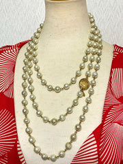 Vintage CHANEL faux pearl necklace, extra long necklace with golden round logo motif. Must have classic jewelry piece. 0408152
