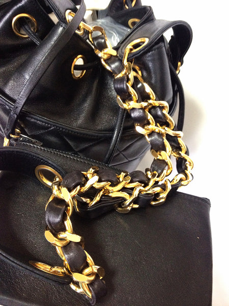 Vintage CHANEL black lamb leather golden chain shoulder bag in round drum  shape.