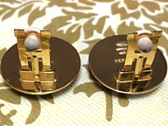 Vintage Hermes cloisonne golden round earrings with female lion design on white and light grey. Great gift idea