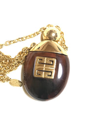 Vintage Givenchy gold chain necklace with gold tone logo motif and brown marble stone perfume bottle pendant top. Statement