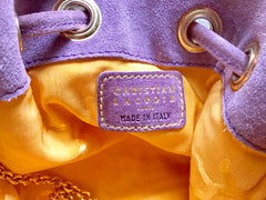 Vintage Christian Lacroix purple suede leather hobo bucket shoulder bag with drawstrings and golden sun, heart etc.. motifs. Unique and chic.