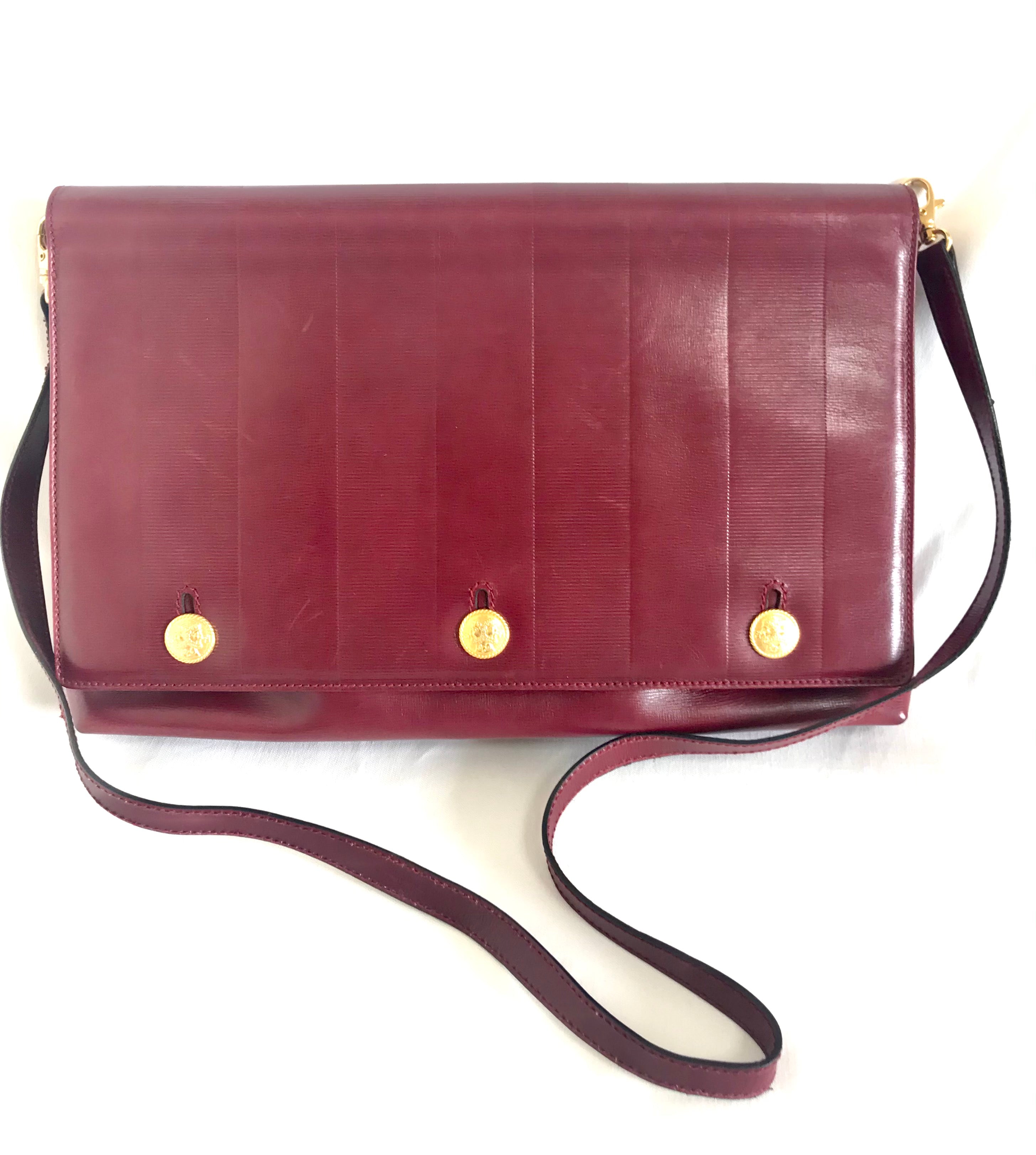 Vintage FENDI wine leather shoulder bag, large clutch purse with iconic Janus medallion embossed motifs at front. Unisex. 060620re5