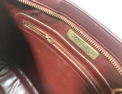 Vintage Cartier kelly style wine leather shoulder bag with a decorative built-in belt. les must de cartier collection.