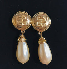 Vintage Givenchy golden round dangle earrings with teardrop faux pearl. Classic and beautiful jewelry piece.