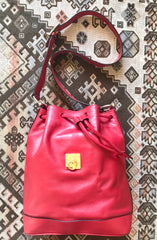 Vintage Celine red leather hobo bucket shoulder bag with a golden square logo motif and matching pouch. Classic drawstrings purse.