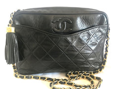 Vintage CHANEL black camera shoulder bag with CC mark stitch and tassel. Classic must have design purse.