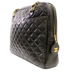 Vintage CHANEL black lamb leather large classic bag with double golden chain strap and a CC pull charm. Perfect daily bag.
