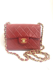 Vintage CHANEL deep red lambskin mini 2.55 bag with golden CC and chain strap. Classic Chanel red bag back in the era.