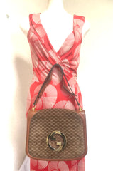 Vintage Gucci brown leather micro GG print shoulder bag with iconic golden large round GG motif. Rare masterpiece purse.