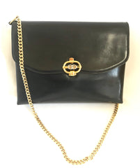 Vintage Gucci black leather shoulder bag with golden and silver tone GG logo motif. Classic purse. Can be clutch bag.