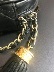 Vintage CHANEL black camera shoulder bag with CC mark stitch and tassel. Classic must have design purse.