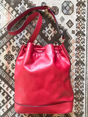 Vintage Celine red leather hobo bucket shoulder bag with a golden square logo motif and matching pouch. Classic drawstrings purse.