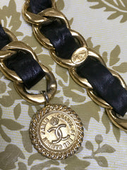 1980s Vintage CHANEL black leather thick chain belt with golden CC and mademoiselle charm. Nice and heavy single layer belt from CHANEL.