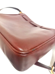 Vintage Cartier kelly style wine leather shoulder bag with a decorative built-in belt. les must de cartier collection.