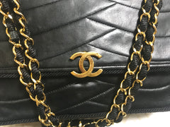 80's vintage Chanel black 2.55 shoulder bag with wavy stitches and rope strings and gold chain strap. Very rare piece from the era