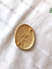 Vintage CHANEL gold tone large brooch in oval coin shape with CC logo and crown embossed motif. Rare masterpiece jewelry. 060620re3