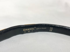Vintage CHANEL black belt with golden buckle and iconic logo motifs, CC mark, camellia flower, turtle, perfume, clover. R0410113