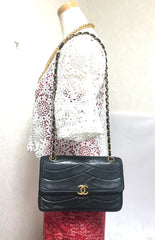 80's vintage Chanel black 2.55 shoulder bag with wavy stitches and rope strings and gold chain strap. Very rare piece from the era