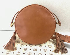 Vintage MCM suzy wong bag, brown grained leather round shoulder bag with studs and fringes. Designed by Michael Cromer.