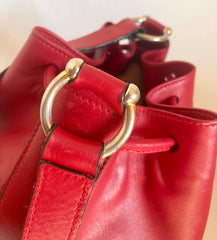 Vintage Celine red leather hobo bucket shoulder bag with a golden square logo motif and matching pouch. Classic drawstrings purse.