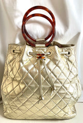 Vintage CHANEL campaign gold lamb leather hobo bucket bag with marble hoop handles and turn lock CC. 0412081