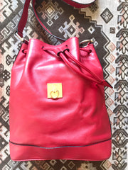 Vintage Celine red leather hobo bucket shoulder bag with a golden square logo motif and matching pouch. Classic drawstrings purse.