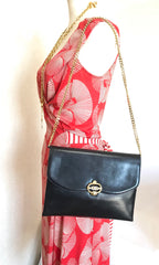 Vintage Gucci black leather shoulder bag with golden and silver tone GG logo motif. Classic purse. Can be clutch bag.