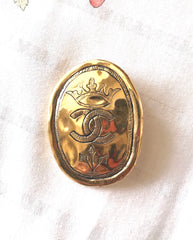 Vintage CHANEL gold tone large brooch in oval coin shape with CC logo and crown embossed motif. Rare masterpiece jewelry. 060620re3