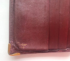 Vintage Cartier, must de Cartier wine leather square wallet with gold tone frames. Unisex use.