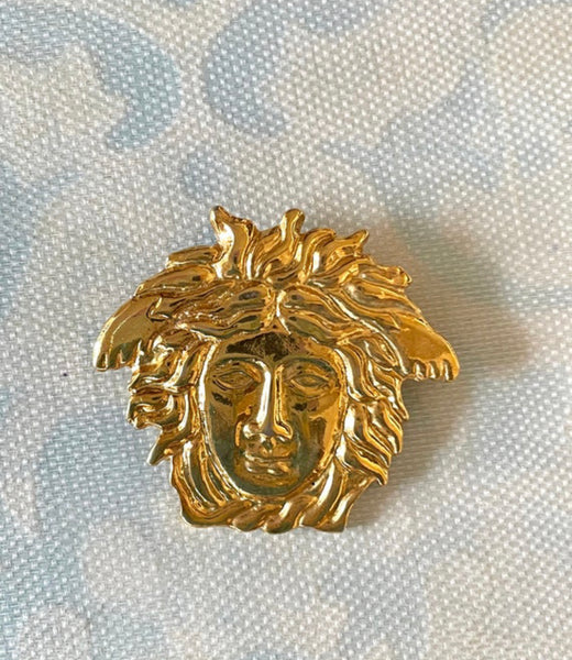 Vintage Gianni Versace gold medusa head face brooch. Can be hat