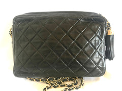 Vintage CHANEL black camera shoulder bag with CC mark stitch and tassel. Classic must have design purse.