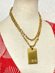 Vintage Celine golden long necklace with blaison macadam charms and square plate with embossed logo and carriage. 041032