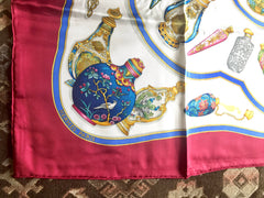 Vintage HERMES Carre large silk scarf with blue, yellow, green, pink, multicolor perfume bottle print in wine. Qu' importe le flacon.