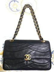 80's vintage Chanel black 2.55 shoulder bag with wavy stitches and rope strings and gold chain strap. Very rare piece from the era