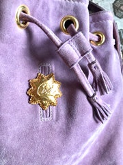 Vintage Christian Lacroix purple suede leather hobo bucket shoulder bag with drawstrings and golden sun, heart etc.. motifs. Unique and chic.