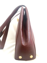 Vintage Salvatore Ferragamo brown leather purse with gold tone elegant closure. Featuring Ferragamo charms. 060516re4