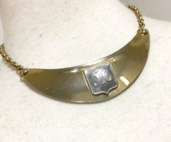 Vintage Celine gold tone crescent moon shape necklace with silver triomphe logo. 05062810