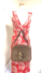 Vintage Gucci brown leather micro GG print shoulder bag with iconic golden large round GG motif. Rare masterpiece purse.