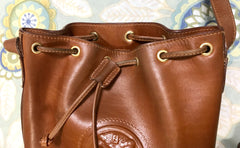 Vintage FENDI brown leather hobo bucket, shoulder bag with drawstring and iconic Janus medallion embossed motif at front. Unisex. Rare bag.