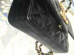 80's vintage CHANEL black lambskin shoulder bag with golden large CC closure and beak tip flap tip. Classic 2.55 bag